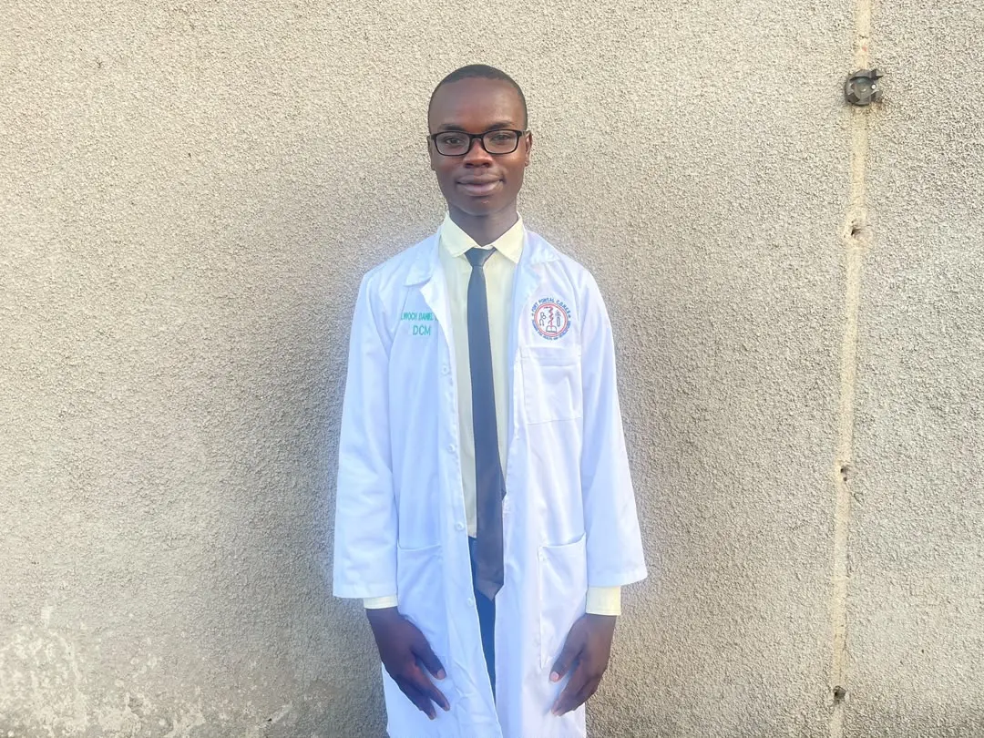 A young man in a graduation gown